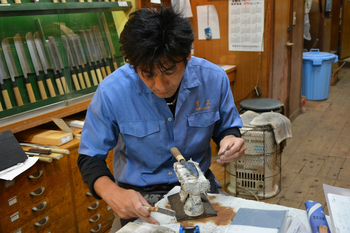 Japanese craftsman attending to his craft