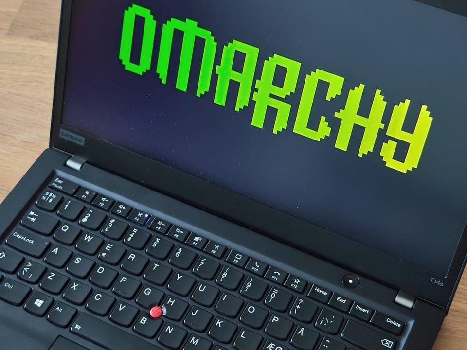 My refurbished Thinkpad T14 Gen 1 showing an Omarchy screensaver.